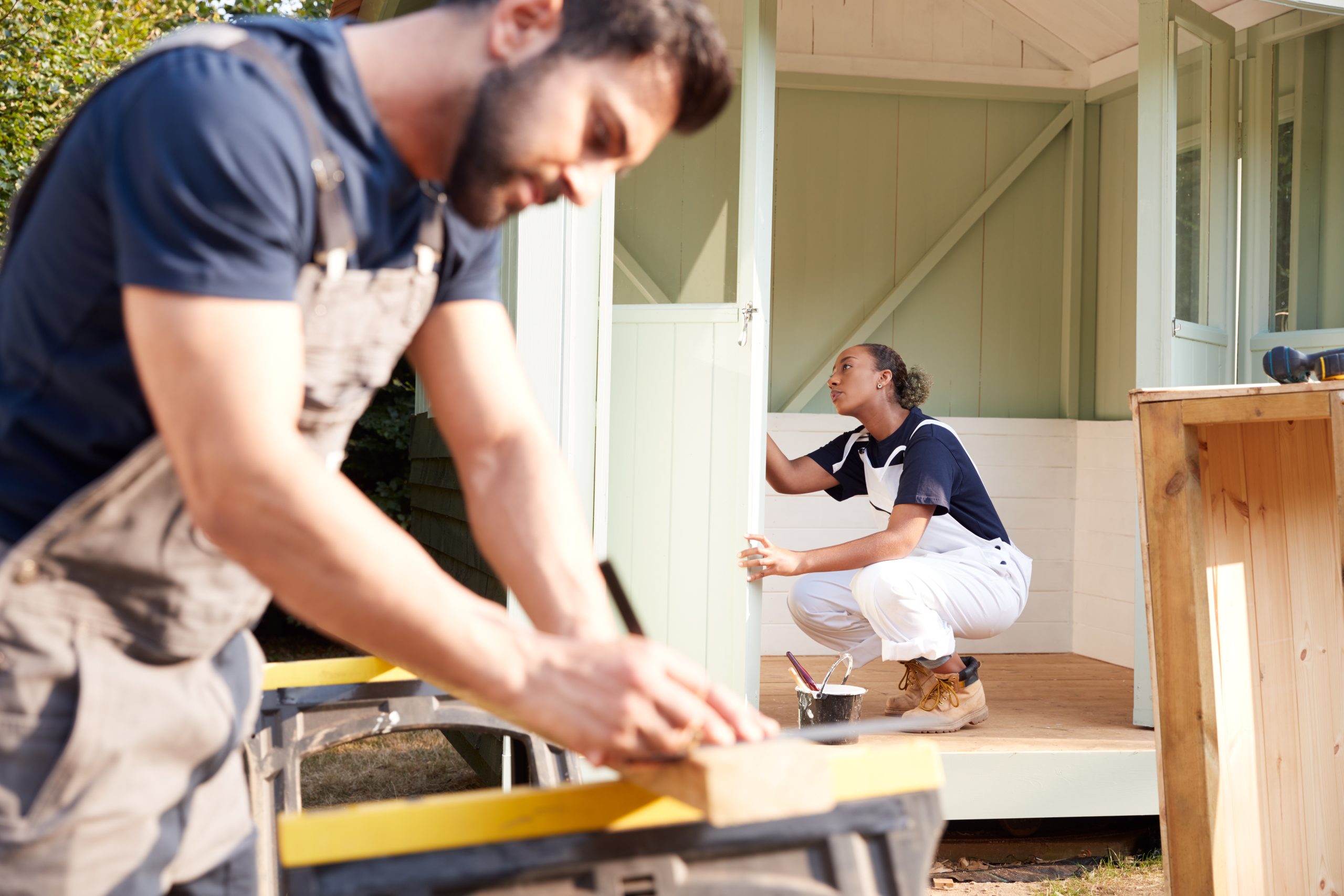 Tradespeople constructing a shed